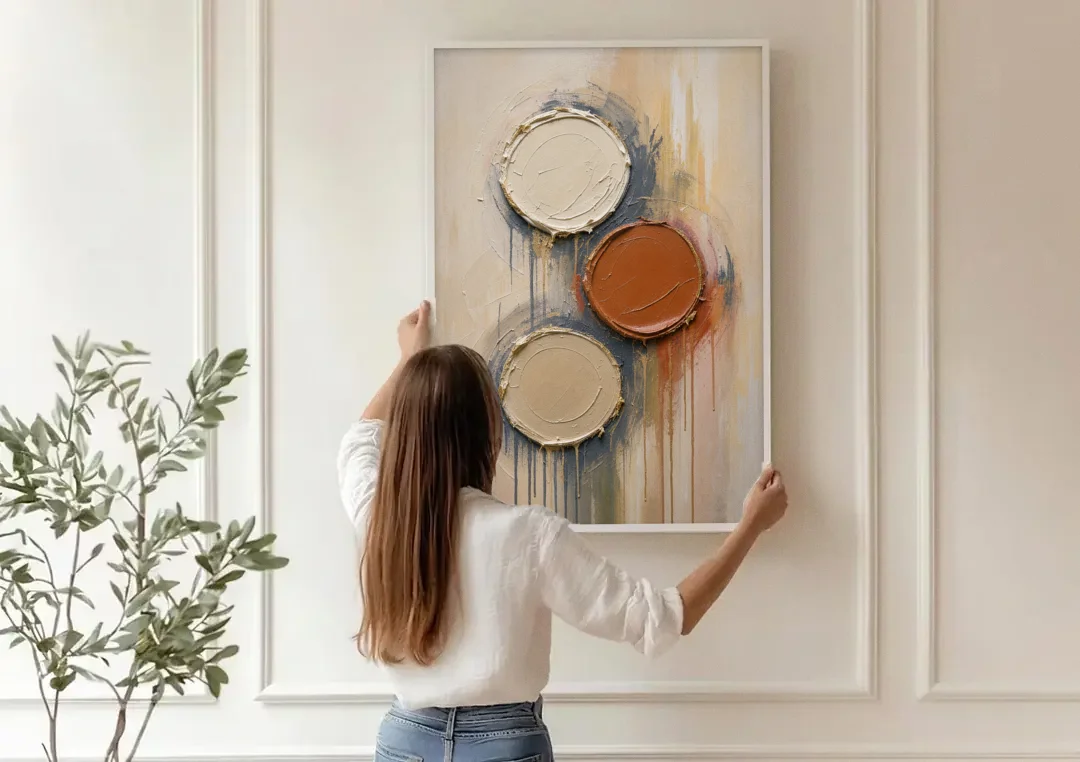 3D Textured Terracotta Disc Trio canvas wall art being hung on a paneled wall