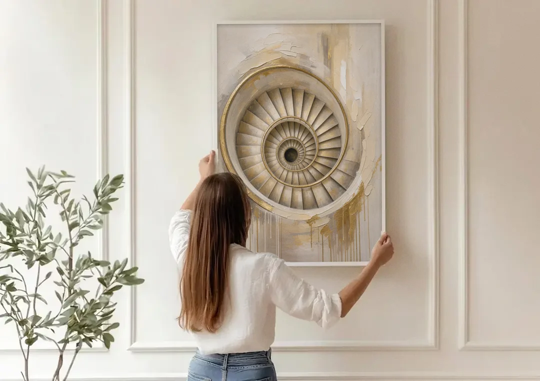 Abstract Architecture Painting of a Gilded Spiral Stair canvas wall art being hung on a paneled wall