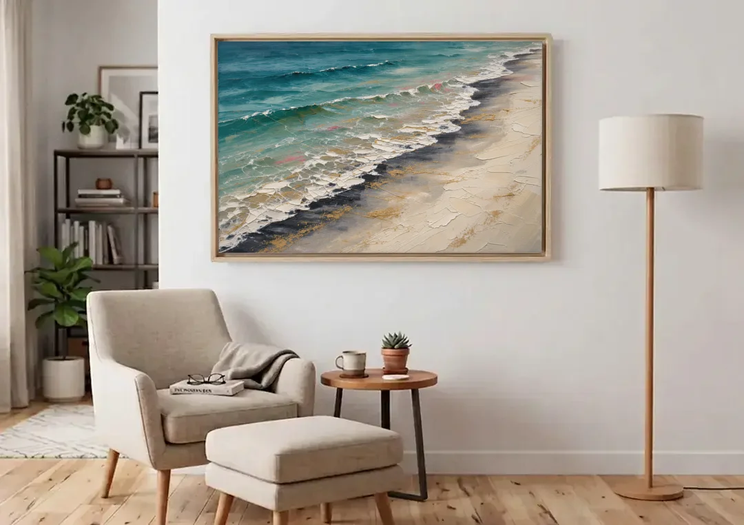 Abstract Beach Painting with Gold Foam Lines canvas wall art above an armchair in a bright living room