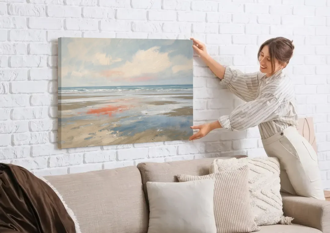 Abstract Beach Wall Art of Coral Tidal Flats canvas wall art being hung on a white brick wall above a sofa