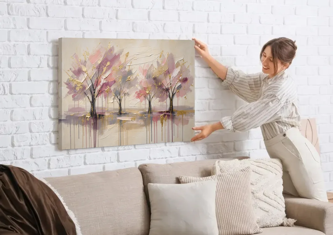 Abstract Cherry Blossom Painting with Gold Drips canvas wall art being hung on a white brick wall above a sofa