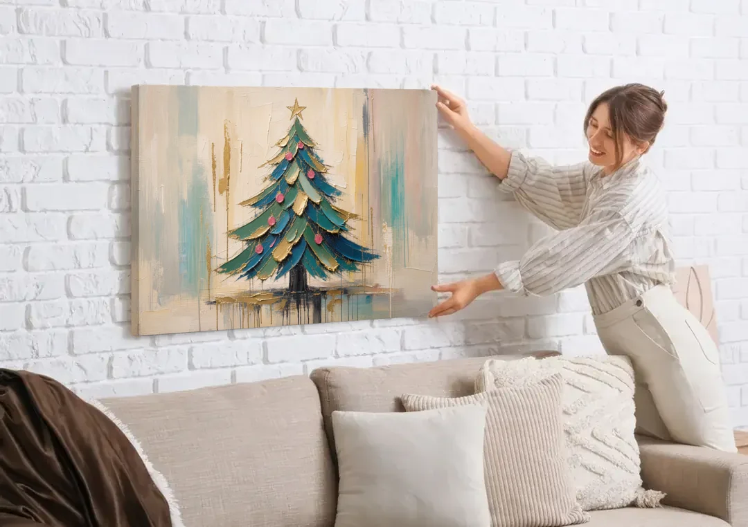 Abstract Christmas Tree Painting in Teal and Gold canvas wall art being hung on a white brick wall above a sofa