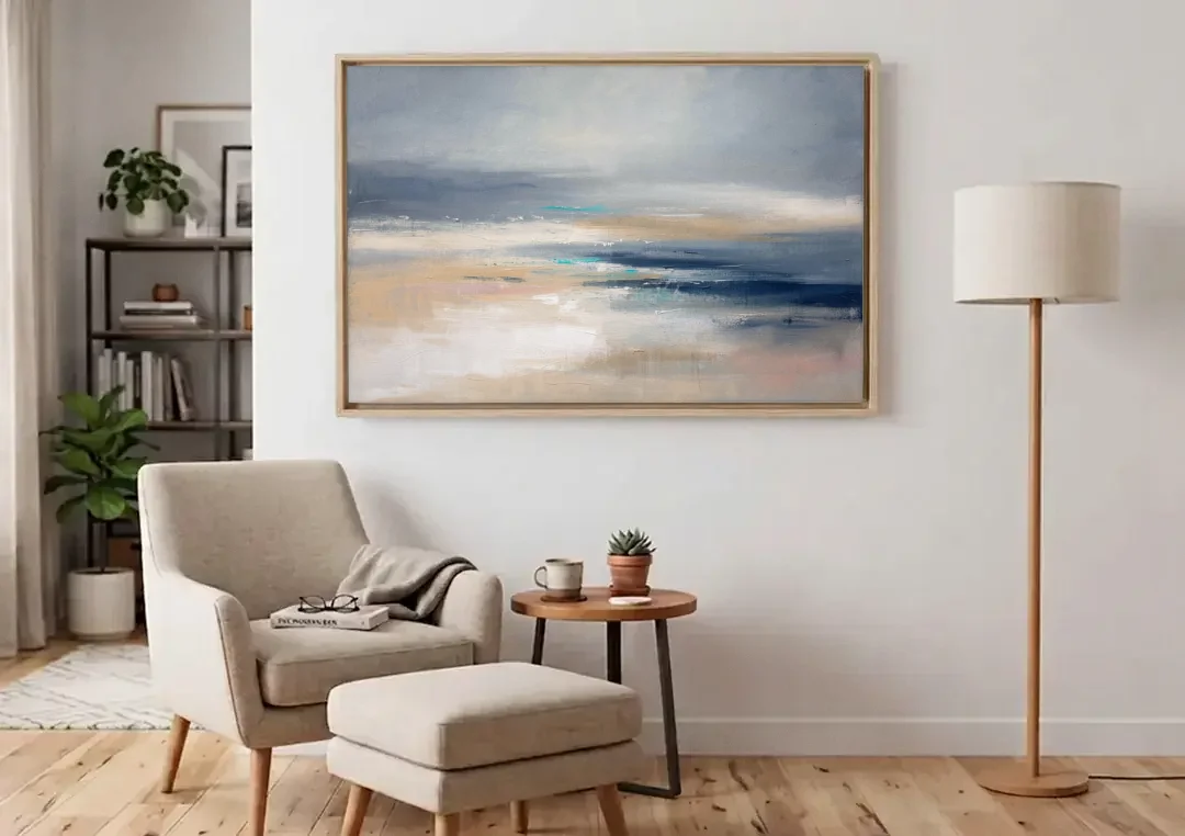 Abstract Horizon Painting in Navy and Mist canvas wall art above an armchair in a bright living room