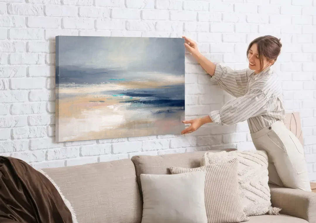 Abstract Horizon Painting in Navy and Mist canvas wall art being hung on a white brick wall above a sofa