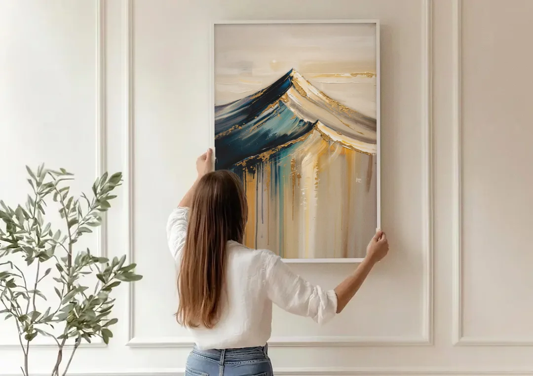 Abstract Mountain Painting with Gold Ridgelines canvas wall art being hung on a paneled wall