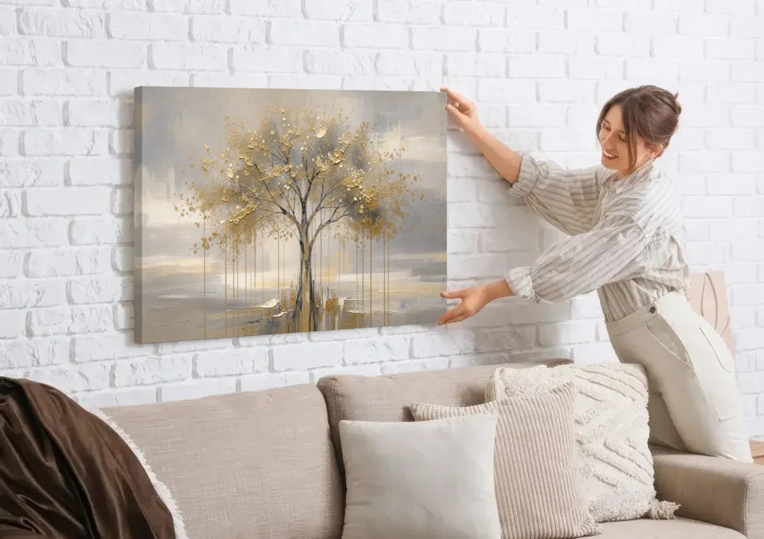 Abstract Tree Painting in Gold Leaf and Cream canvas wall art being hung on a white brick wall above a sofa