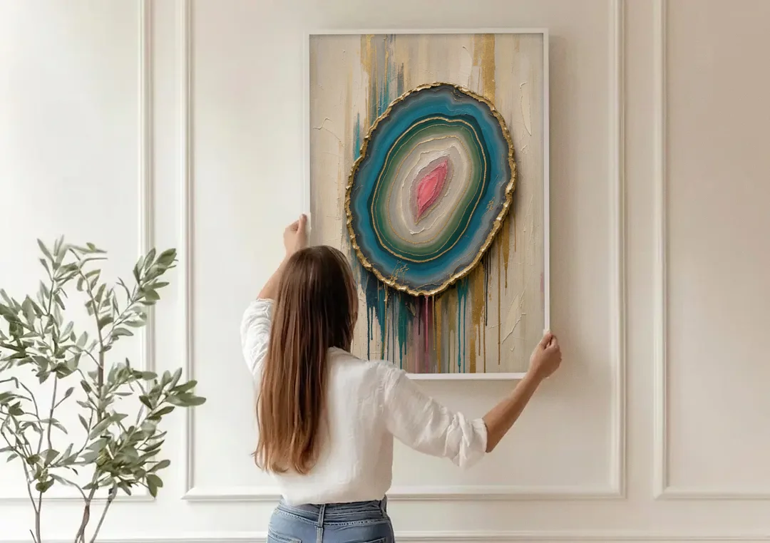 Agate Slice with Gold Rim and Teal Drips canvas wall art being hung on a paneled wall