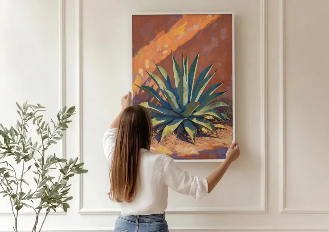 Agave Painting Against a Sunlit Adobe Wall canvas wall art being hung on a paneled wall
