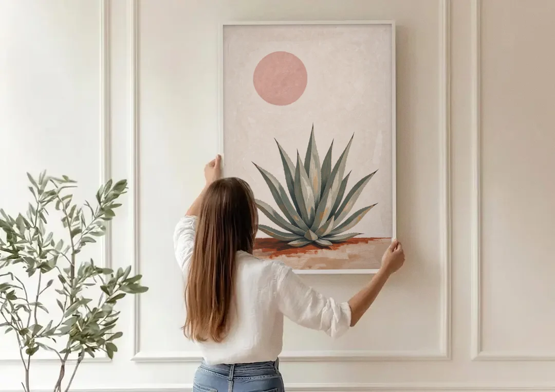 Agave Rosette Under a Blush Pink Sun canvas wall art being hung on a paneled wall