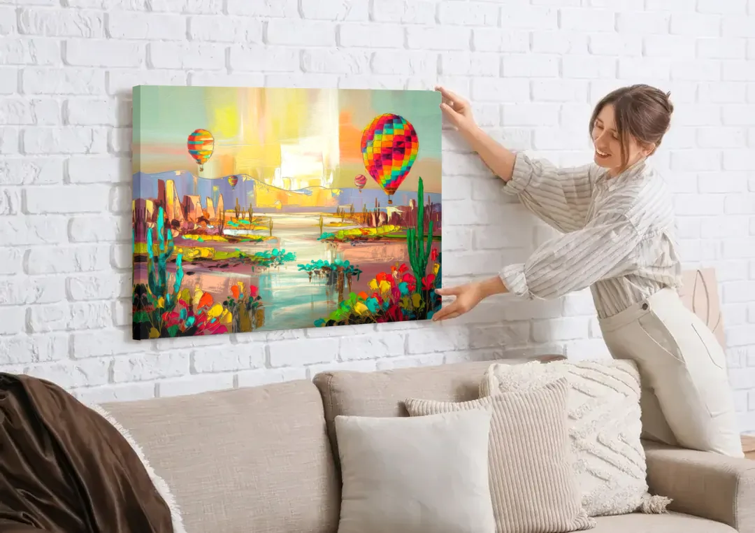 Albuquerque Hot Air Balloons canvas wall art being hung on a white brick wall above a sofa