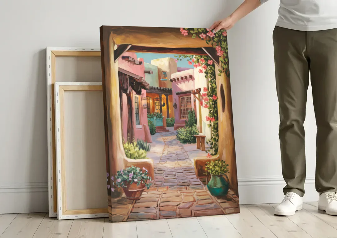 Albuquerque Old Town Charm canvas wall art leaning against a wall next to blank canvases