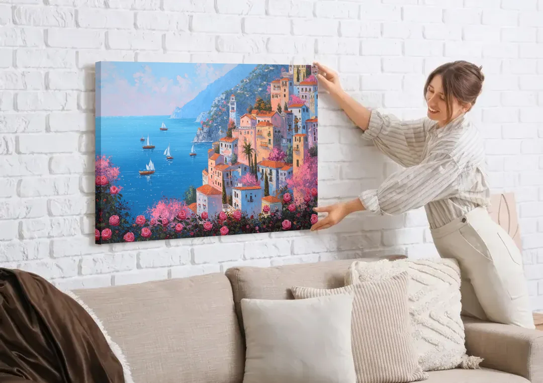 Amalfi Coast Painting with Sailboats canvas wall art being hung on a white brick wall above a sofa