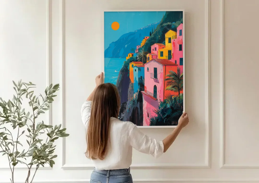 Amalfi Painting of Pink Cliff Houses canvas wall art being hung on a paneled wall