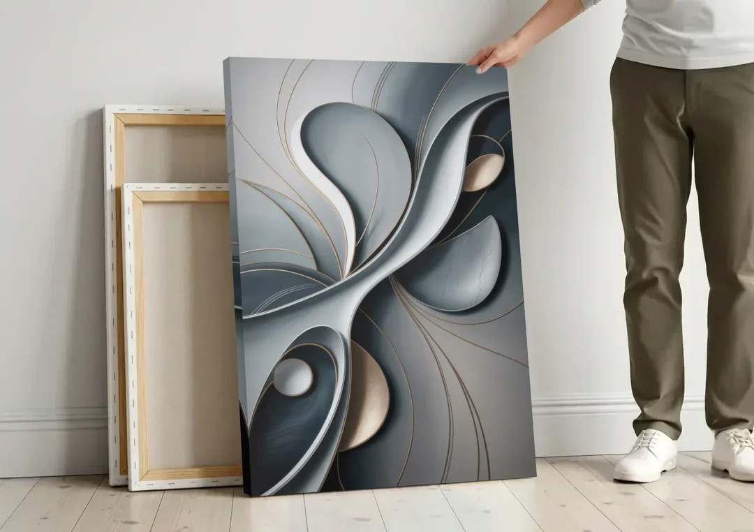 Amorphous Curves in Grey Abstract canvas wall art leaning against a wall next to blank canvases