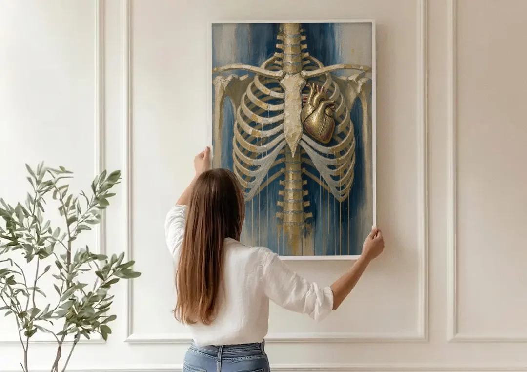 Anatomical Wall Art with a Gilded Heart Within canvas wall art being hung on a paneled wall
