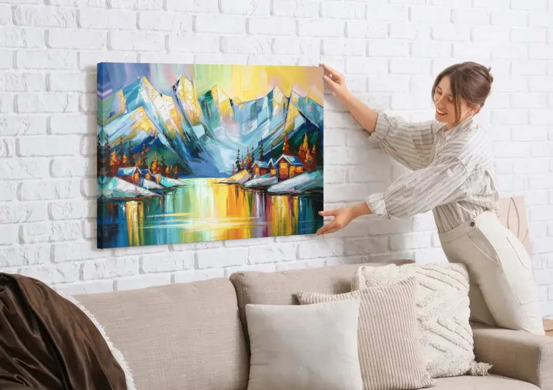 Anchorage Mountain Views canvas wall art being hung on a white brick wall above a sofa