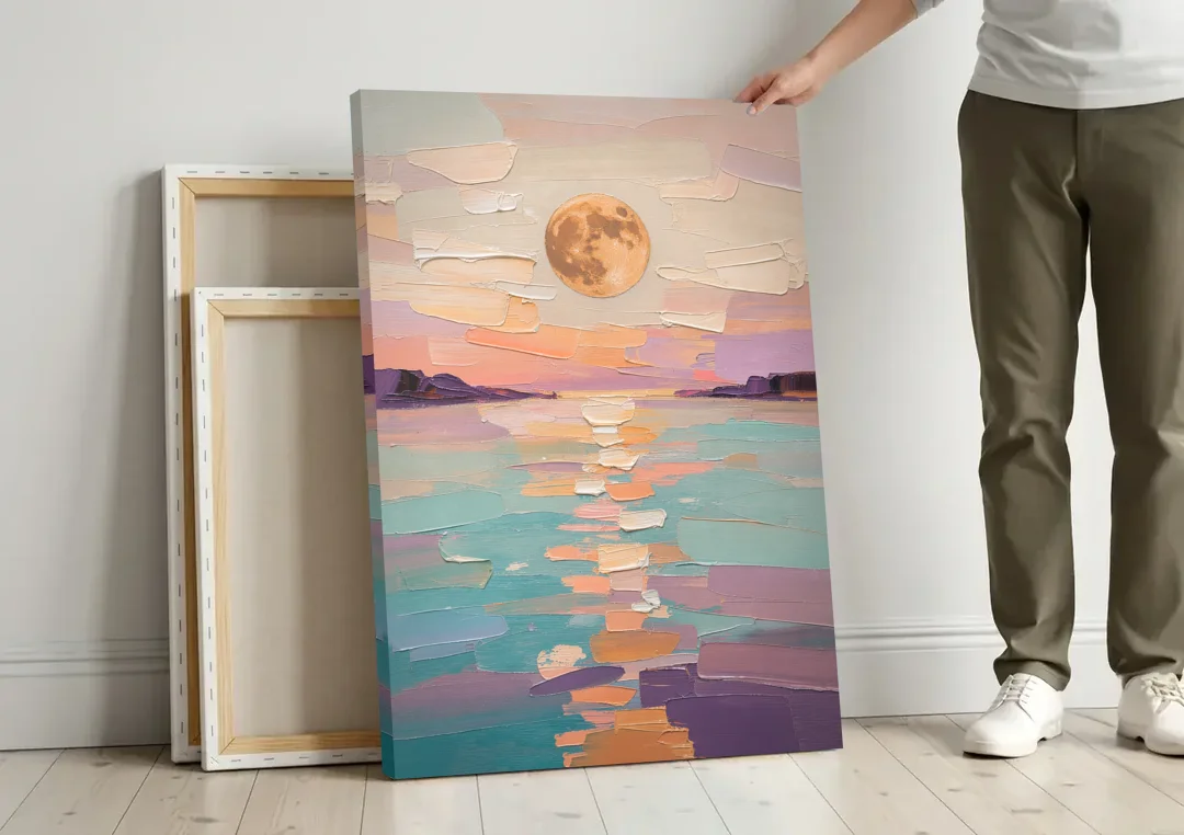Apricot Moon Over a Teal Lagoon canvas wall art leaning against a wall next to blank canvases