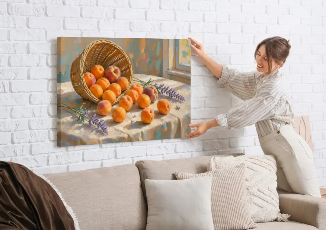 Apricots and Lavender Spilling from Wicker for the Kitchen canvas wall art being hung on a white brick wall above a sofa