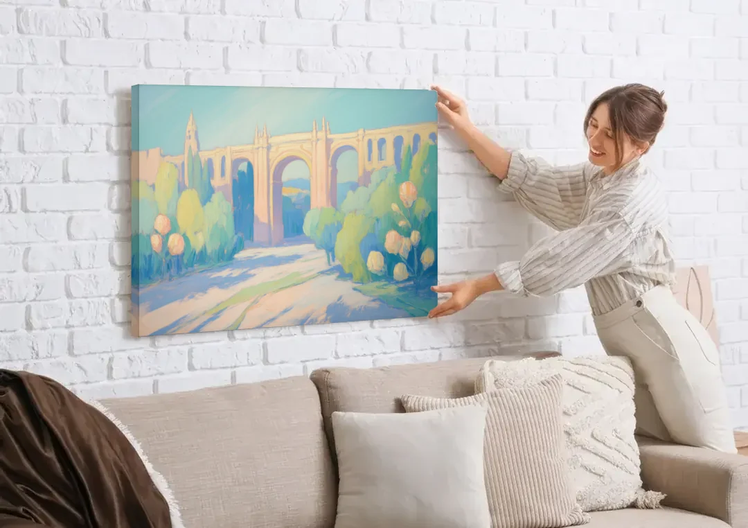 Arcos de Guadalajara canvas wall art being hung on a white brick wall above a sofa