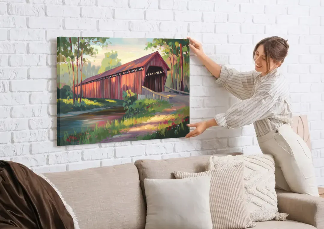 Ashland Covered Bridge canvas wall art being hung on a white brick wall above a sofa