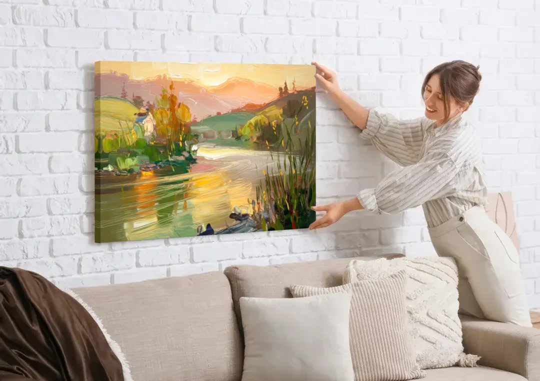 Ashland Riverfront Scene canvas wall art being hung on a white brick wall above a sofa