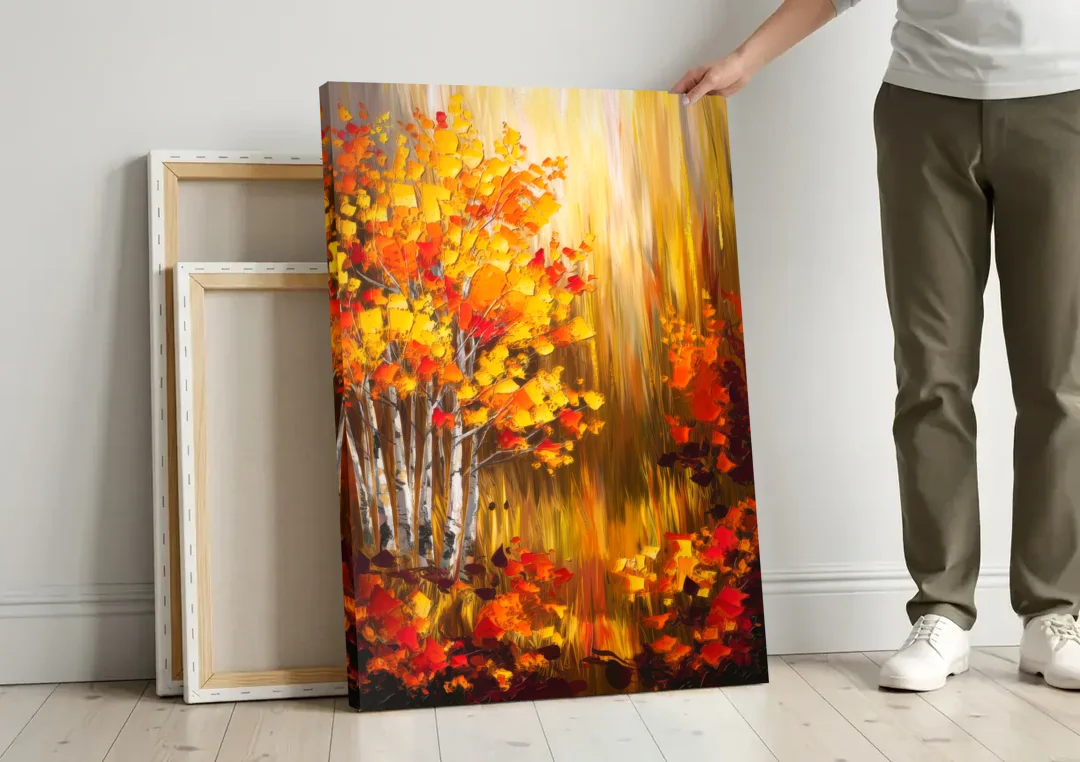 Aspen Forest in Autumn canvas wall art leaning against a wall next to blank canvases