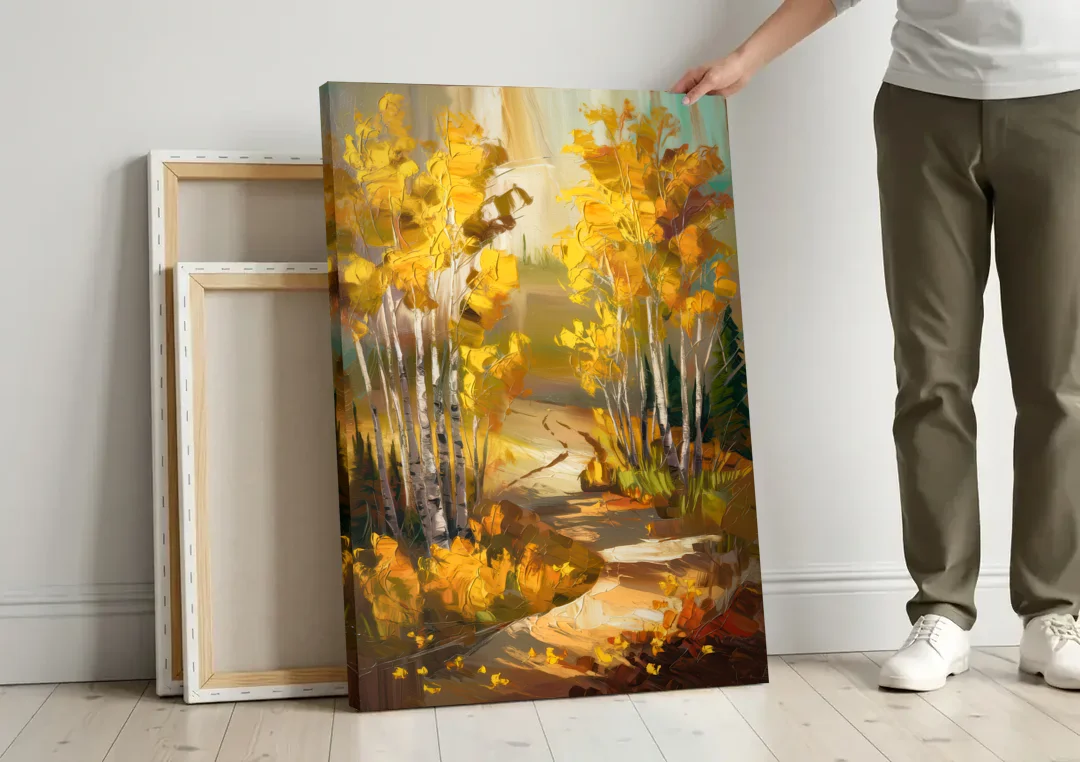 Aspen Trail Through the Trees canvas wall art leaning against a wall next to blank canvases