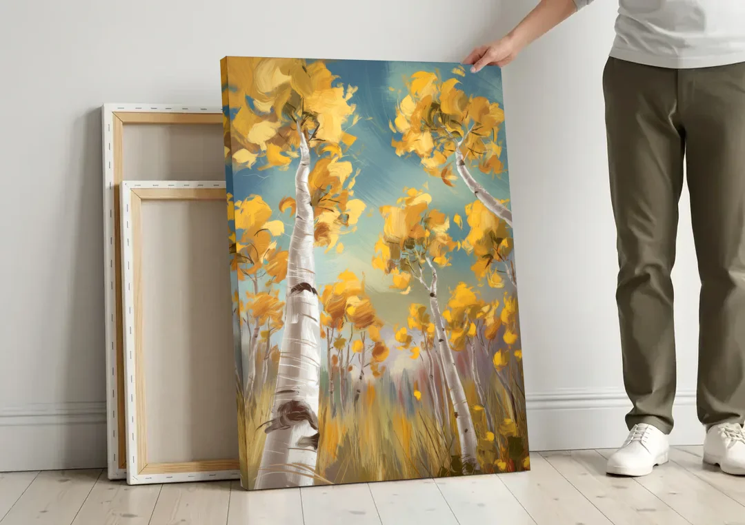 Aspen Tree Canopy canvas wall art leaning against a wall next to blank canvases
