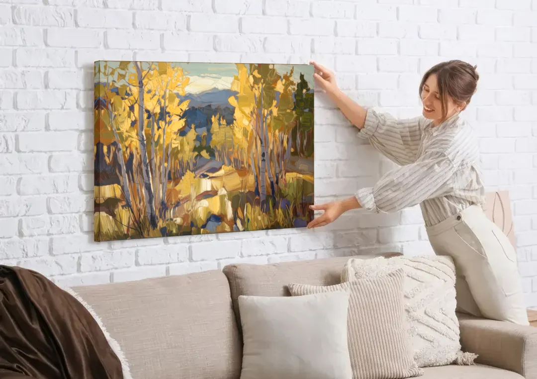 Aspen Wilderness Beauty canvas wall art being hung on a white brick wall above a sofa