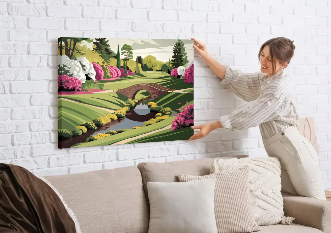 Augusta National Green Landscape canvas wall art being hung on a white brick wall above a sofa