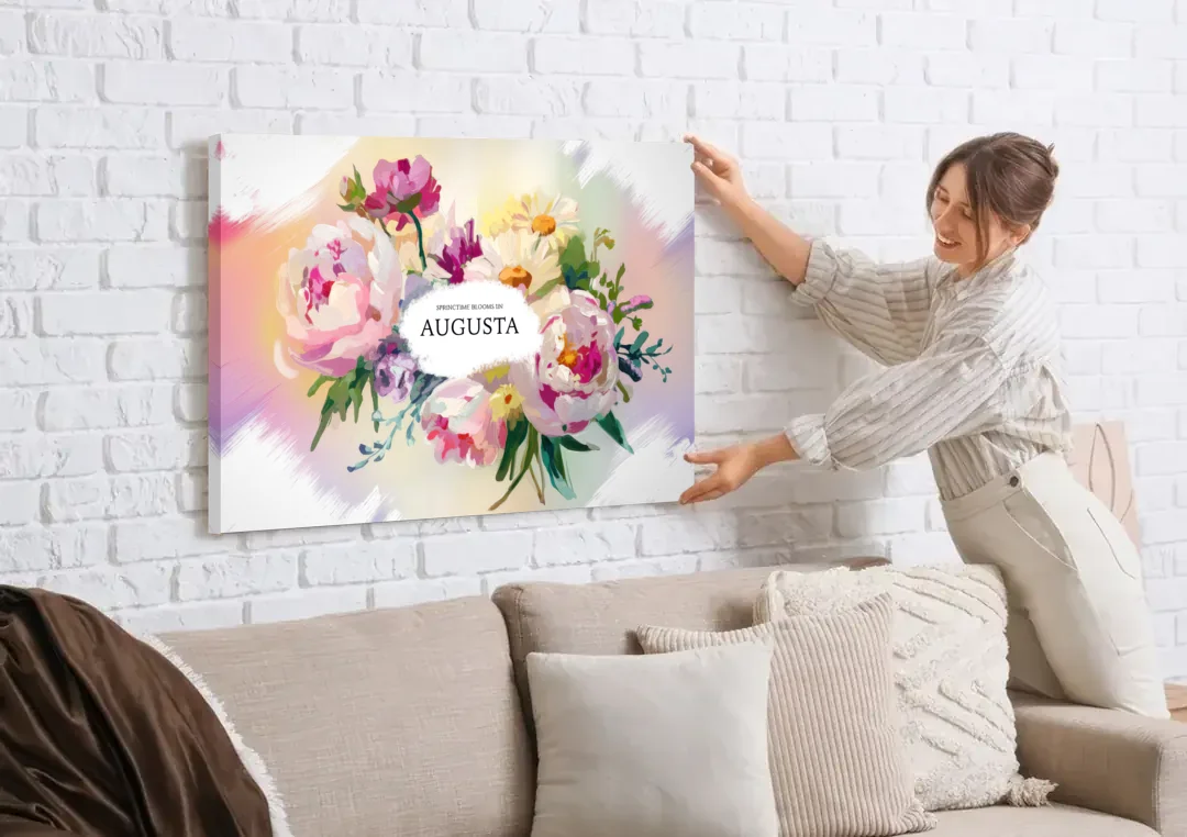 Augusta Springtime Blooms canvas wall art being hung on a white brick wall above a sofa