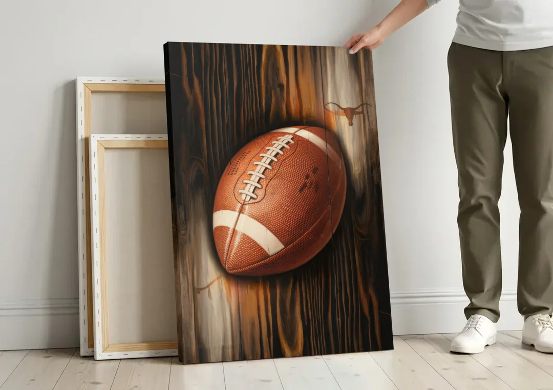 Austin UT Football Energy canvas wall art leaning against a wall next to blank canvases