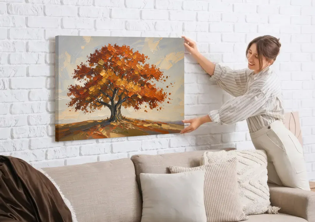 Autumn Tree Painting with Windblown Oak Leaves canvas wall art being hung on a white brick wall above a sofa
