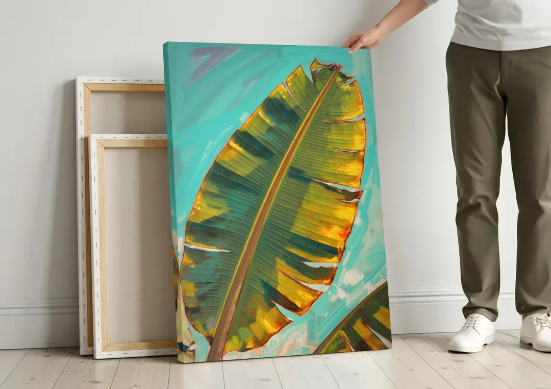Banana Leaf Wall Art in Golden Backlight canvas wall art leaning against a wall next to blank canvases