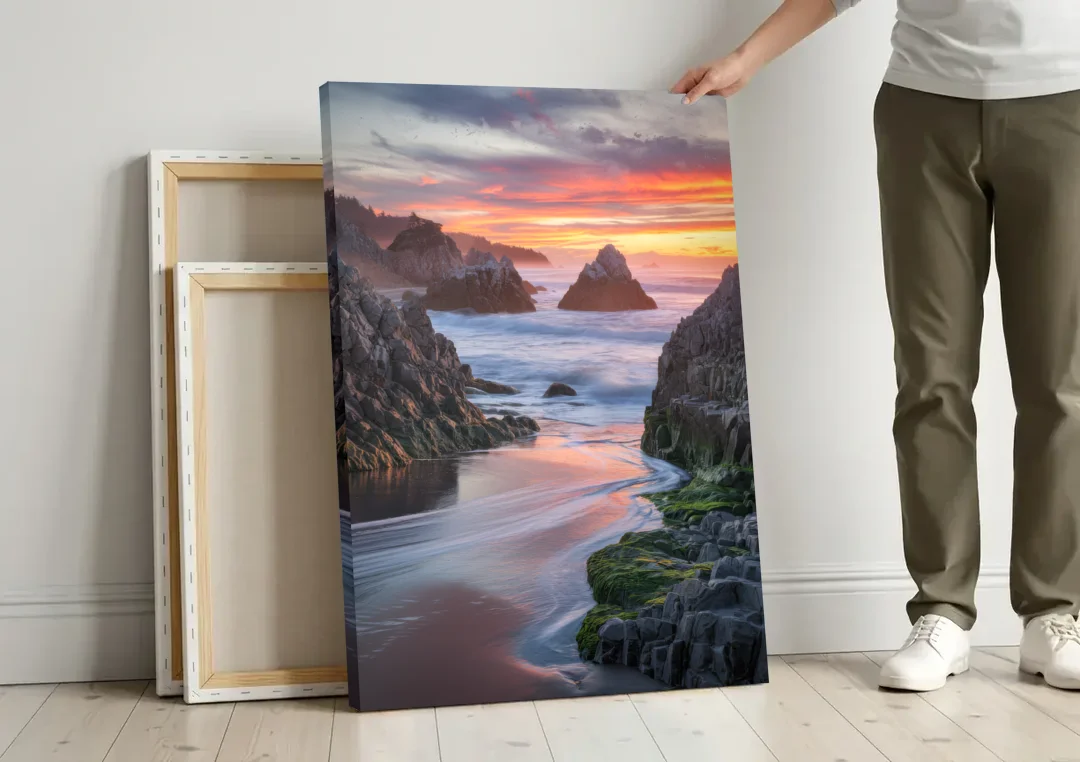 Bandon Rocky Shoreline canvas wall art leaning against a wall next to blank canvases