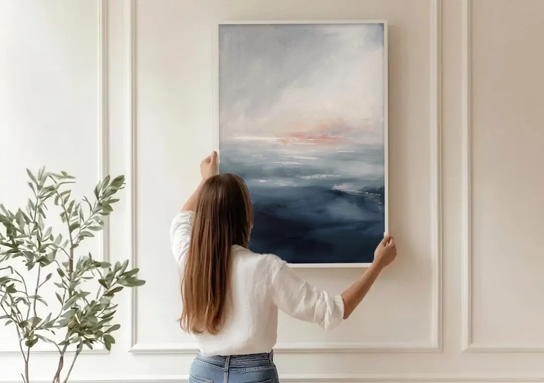 Bathroom Paintings Blush Dawn Over a Misty Sea canvas wall art being hung on a paneled wall