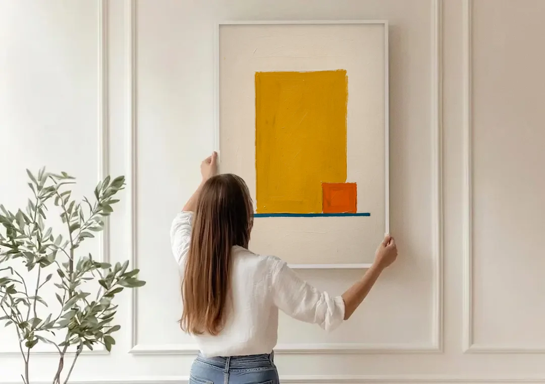 Bauhaus Wall Art with Yellow Block and Orange Square canvas wall art being hung on a paneled wall