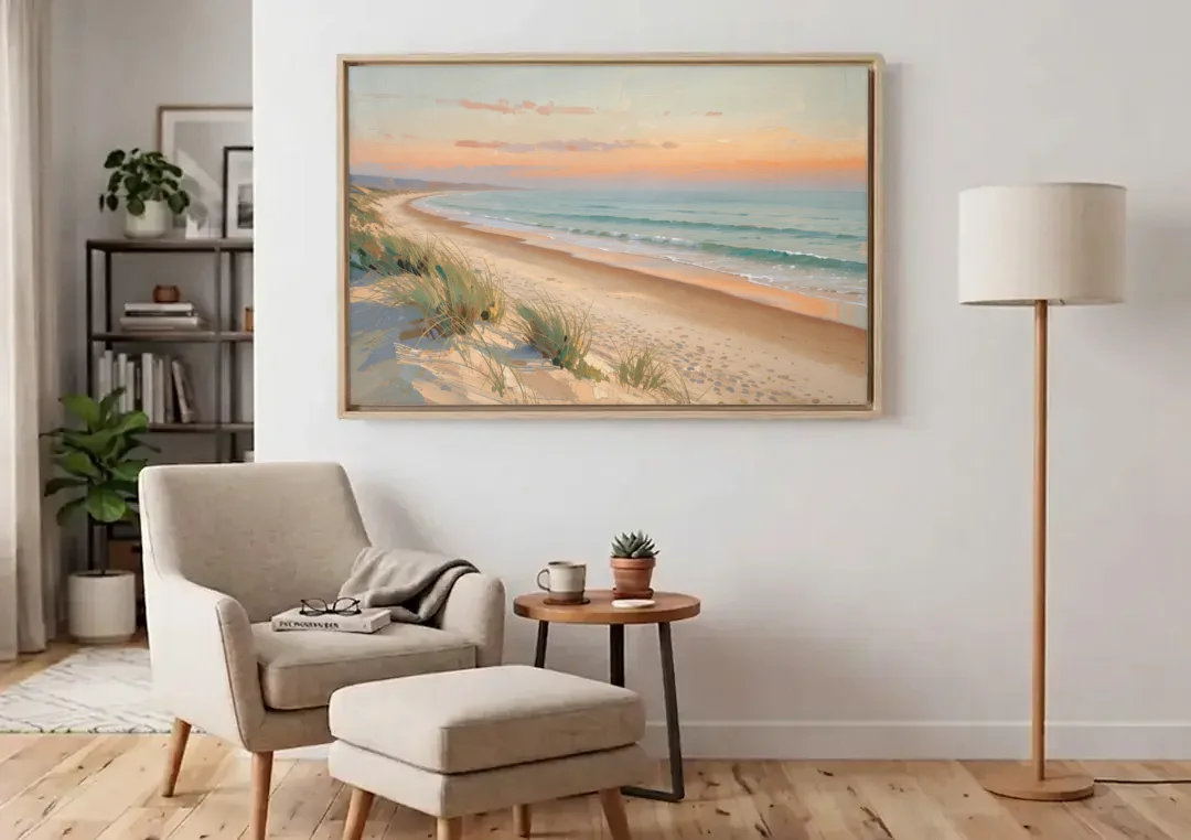 Beach Landscape Painting at First Light canvas wall art above an armchair in a bright living room