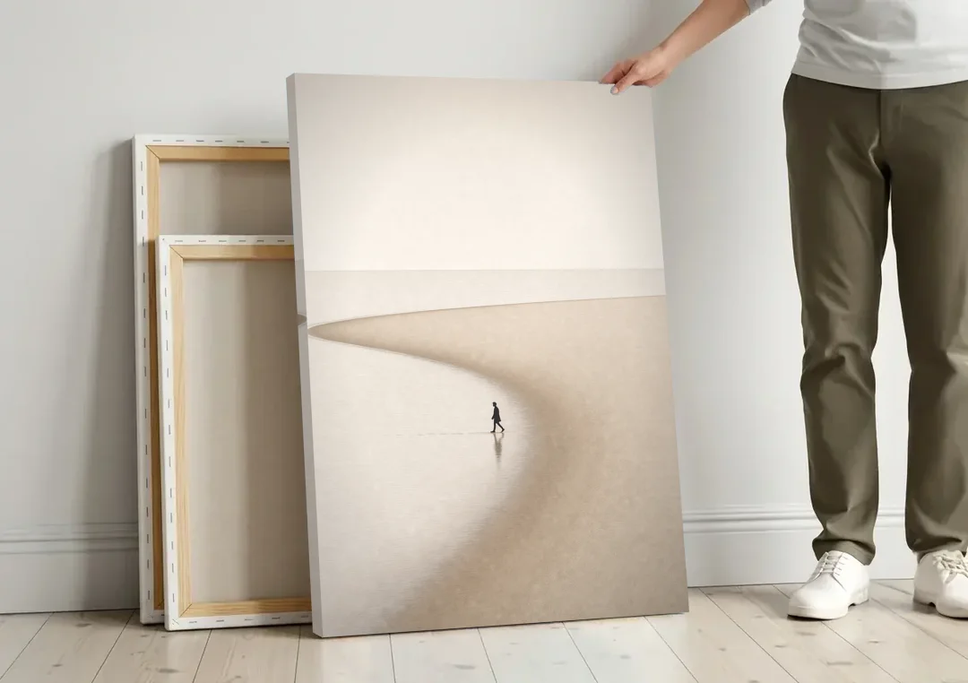 Beach Minimalist Art of a Lone Walker canvas wall art leaning against a wall next to blank canvases