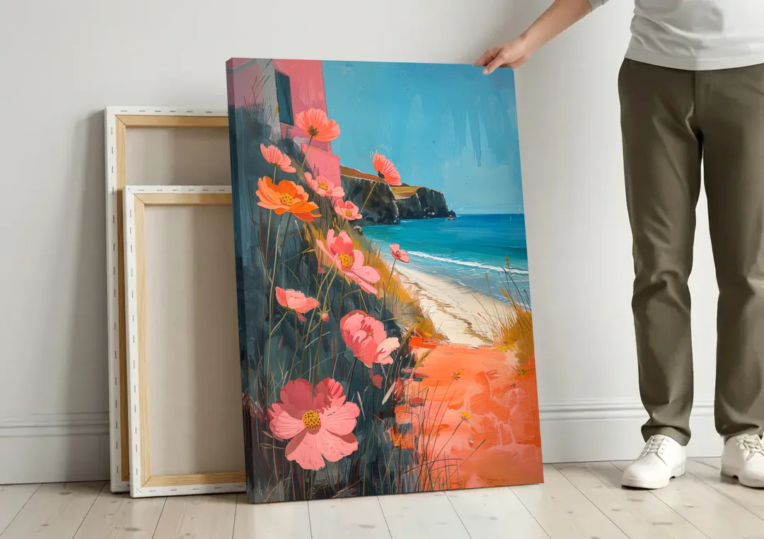 Beach Painting with Pink Cosmos Flowers canvas wall art leaning against a wall next to blank canvases