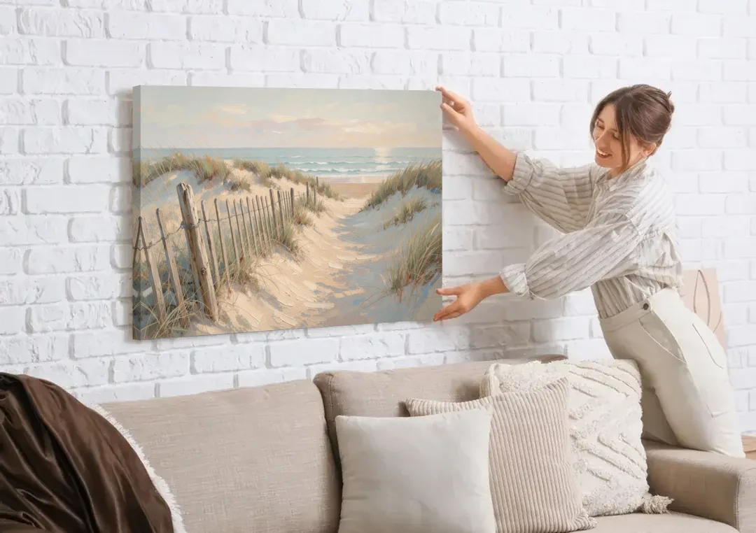 Beachy Wall Decor with a Weathered Dune Fence canvas wall art being hung on a white brick wall above a sofa