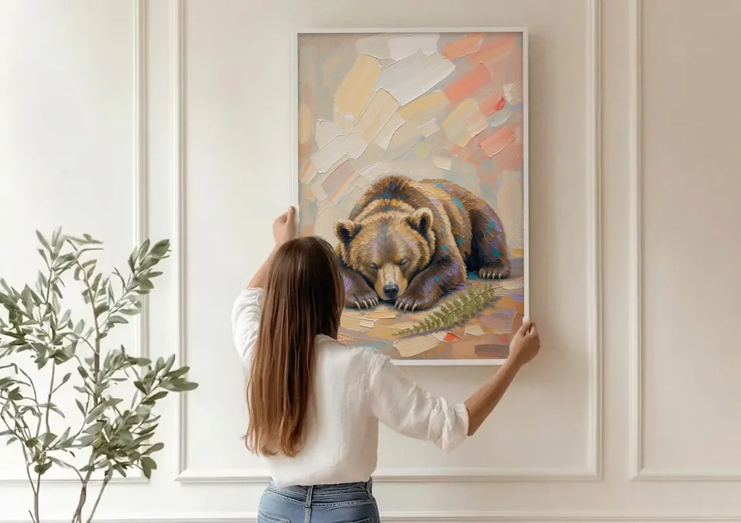 Bear Cub Painting Asleep on Its Paws canvas wall art being hung on a paneled wall
