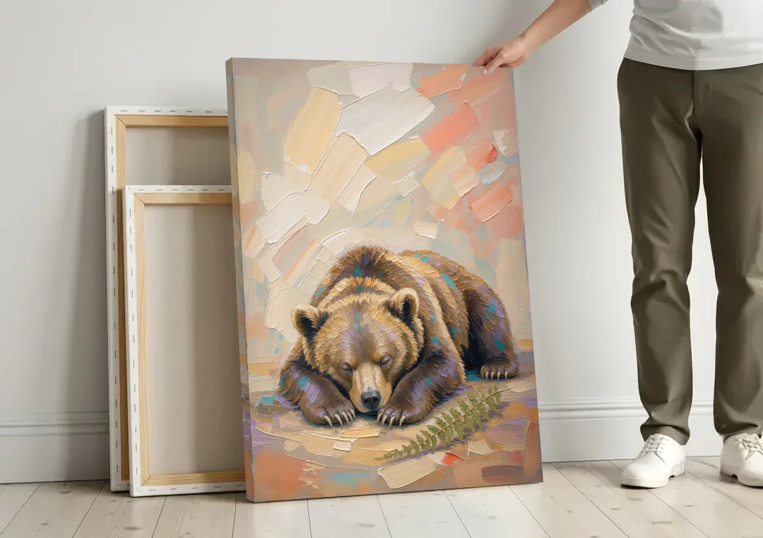 Bear Cub Painting Asleep on Its Paws canvas wall art leaning against a wall next to blank canvases