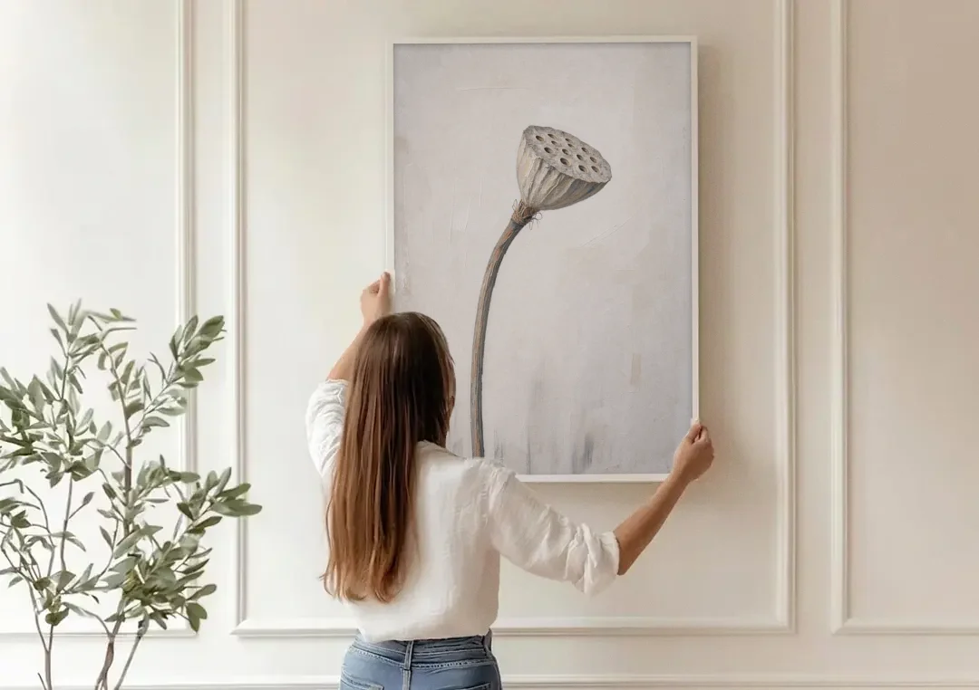 Beige Abstract Canvas Art with a Dried Lotus Pod canvas wall art being hung on a paneled wall