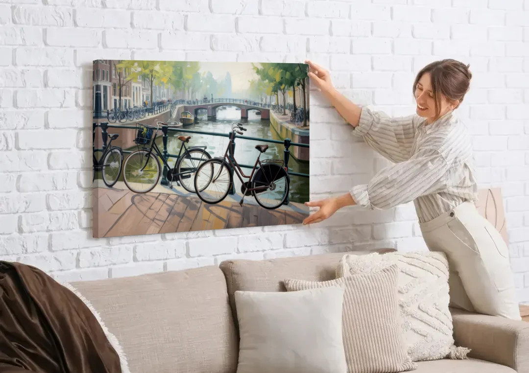 Bicycles of Amsterdam canvas wall art being hung on a white brick wall above a sofa