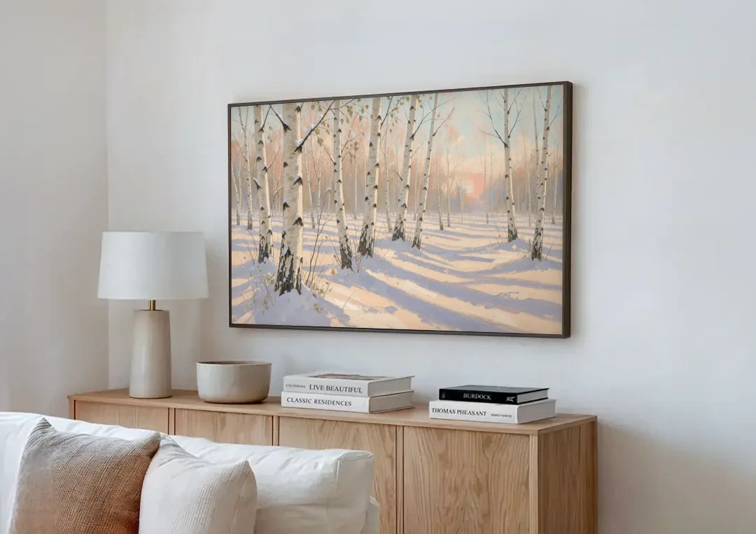 Birch Forest Painting in Morning Snow canvas wall art above a wooden sideboard next to a sofa