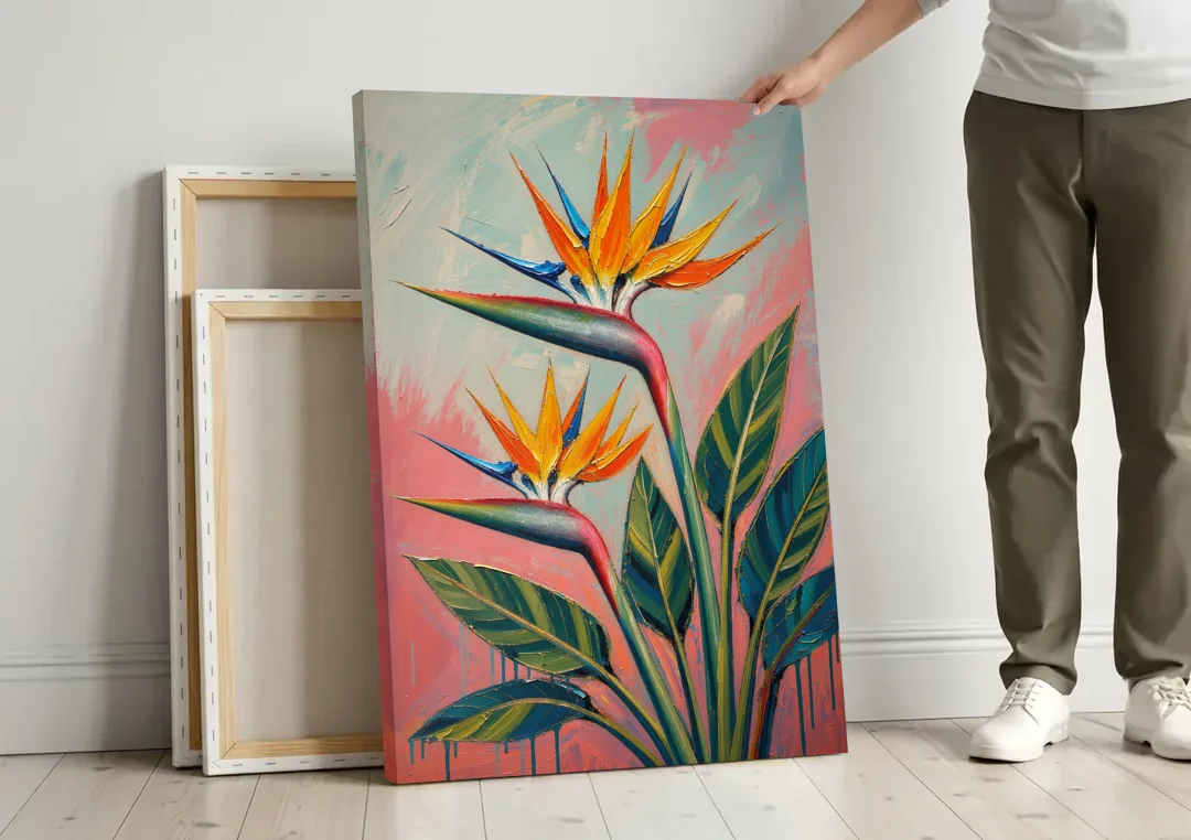 Bird of Paradise Painting in Coral Heat canvas wall art leaning against a wall next to blank canvases