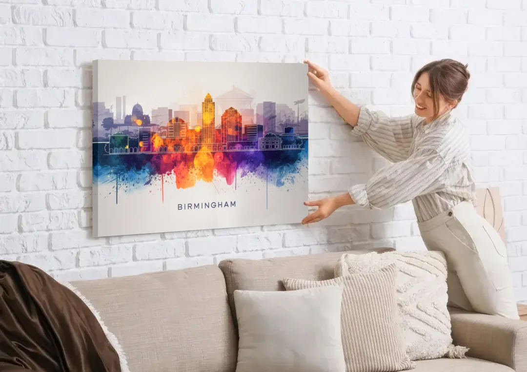 Birmingham Downtown Skyline canvas wall art being hung on a white brick wall above a sofa