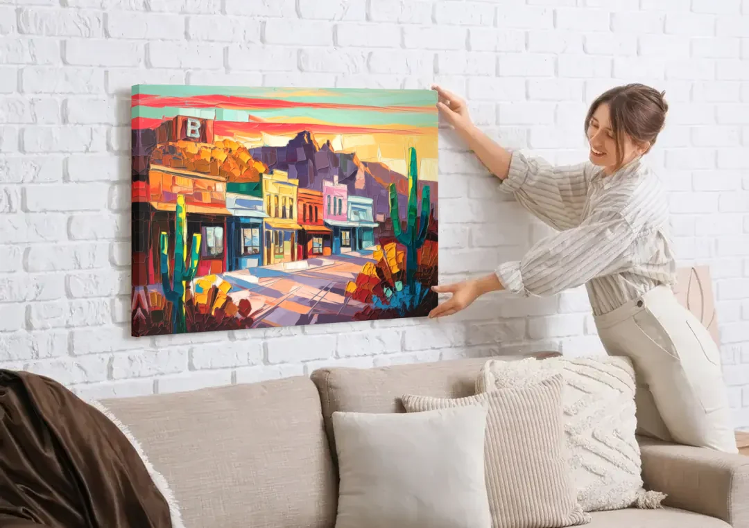 Bisbee Arizona Charm canvas wall art being hung on a white brick wall above a sofa