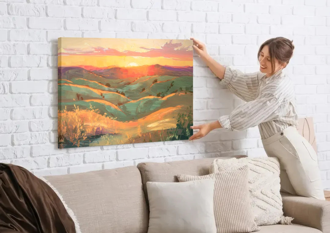Bisbee Sunset Over Hills canvas wall art being hung on a white brick wall above a sofa